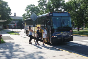 college students getting on a Northstar Link Bus at the Miller Center at St. Cloud State University