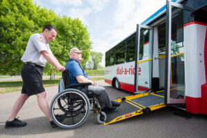MetroBus_Todd-8950 Dial-a-Ride Operator pushing a passenger in a wheelchair onto the Dial-a-Ride bus.
