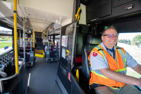 Interior of a fixed route metro bus; operator driving; passengers riding