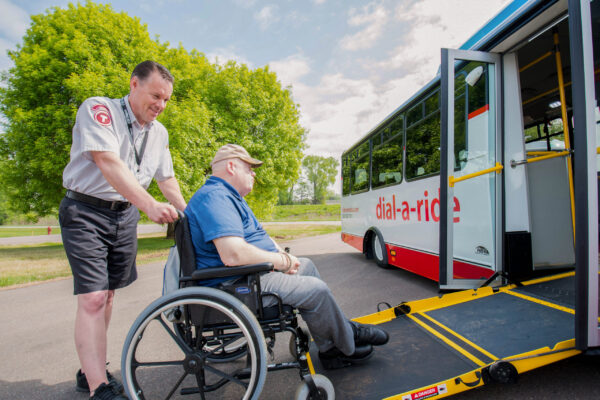 MetroBus_Todd-8871 Dial-a-Ride Operator pushing a passenger in a wheelchair onto the Dial-a-Ride bus.