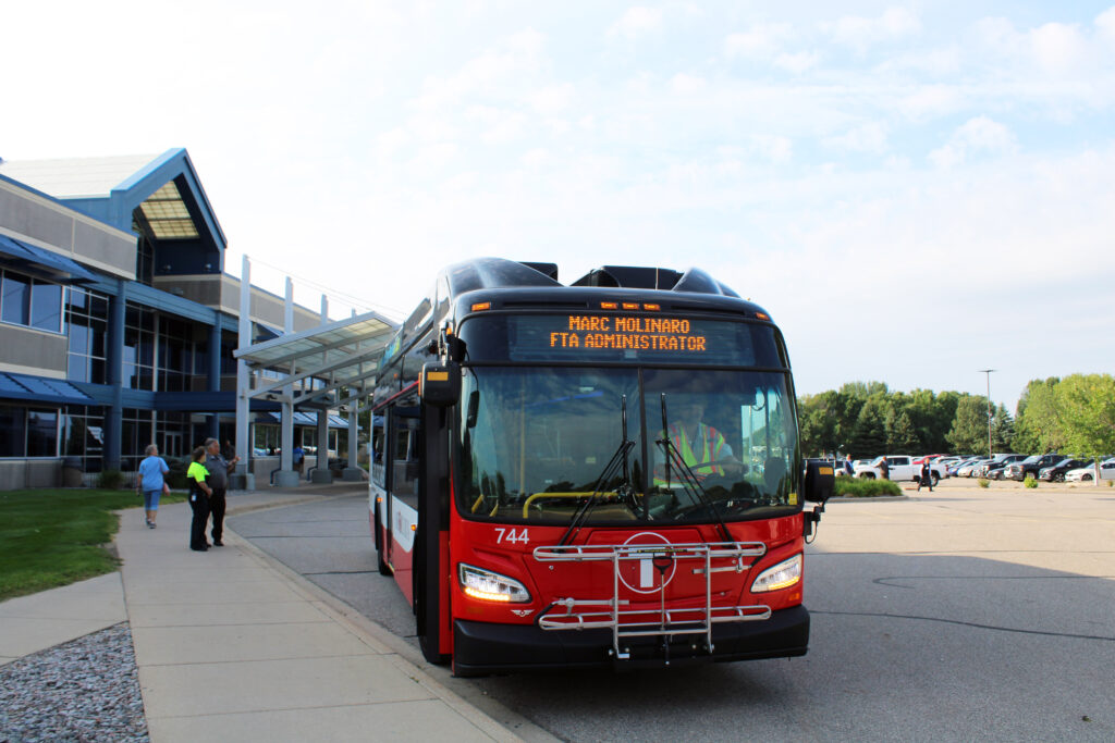 A Metro Bus pulling up in front of the New Flyer facility.