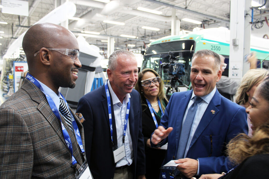 A group talking with FTA Administrator Marc Molinaro at the New Flyer facility.