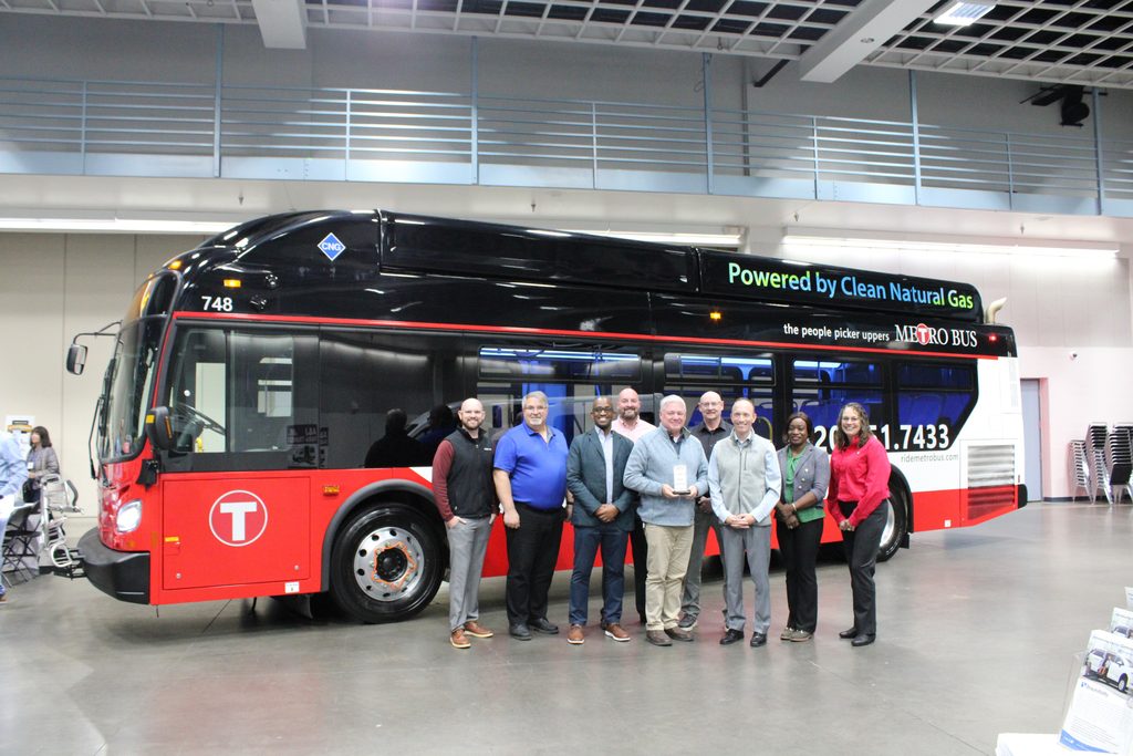 Picture of a group of people in front of a Metro Bus Fixed Route bus.